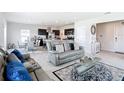 Spacious living room featuring tile floors, modern furniture, and seamless flow into kitchen at 1508 Majestic Ln, Winter Haven, FL 33880