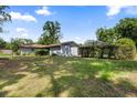 Lush backyard featuring mature trees, and screened-in pool, creating a private outdoor oasis at 19795 Sw 85Th Loop, Dunnellon, FL 34432