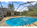 Inviting screened-in pool area features a sparkling pool and ample space for outdoor relaxation and entertaining at 19795 Sw 85Th Loop, Dunnellon, FL 34432