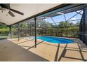 Inviting screened-in pool area features a sparkling pool and ample space for outdoor relaxation and entertaining at 19795 Sw 85Th Loop, Dunnellon, FL 34432