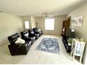 Cozy living room featuring comfortable seating, natural light, and a decorative area rug at 1310 Payne St, Auburndale, FL 33823
