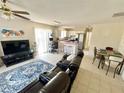 Open-concept living space with stylish furniture, connected to the kitchen and dining area at 1310 Payne St, Auburndale, FL 33823