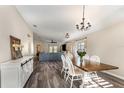 Bright dining room with wood table, white chairs, and view into the living space at 6050 Eagle Pointe Dr, Lakeland, FL 33812