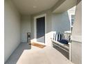 Inviting front porch features a bench with striped pillows and a 'Welcome' mat at 6050 Eagle Pointe Dr, Lakeland, FL 33812