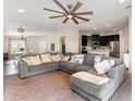 Open-concept living room with a large sectional sofa and view of the kitchen and dining area at 6050 Eagle Pointe Dr, Lakeland, FL 33812