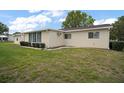 Side view of a home showing the well-manicured lawn and clean exterior at 9755 Se 176Th St, Summerfield, FL 34491