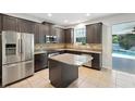 Modern kitchen with stainless steel appliances, granite countertops, and a central island at 3848 Spirited Cir, St Cloud, FL 34772