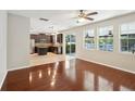 Open living space featuring hardwood floors, natural light, and a view into the kitchen at 3848 Spirited Cir, St Cloud, FL 34772