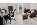 Home office featuring a desk, chair, ottoman, and window with natural light at 1803 Daybreak Dr, Fruitland Park, FL 34731