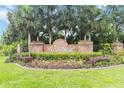 Wedgefield community sign with palm trees and manicured landscaping at the entrance at 2524 Albion Ave, Orlando, FL 32833