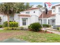 Home featuring green landscaping, a red tile roof, white stucco, and a black flag at 2524 Albion Ave, Orlando, FL 32833
