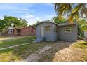Cozy single-story home with a small porch and well-maintained yard at 1224 S Delaware Ave, Deland, FL 32720