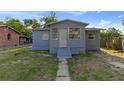 Modest single-story home with a neutral-colored exterior and small front lawn at 1224 S Delaware Ave, Deland, FL 32720