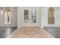 Elegant entryway features decorative tiled floor and glass paneled front door at 239 Beacon Pointe Dr, Ocoee, FL 34761