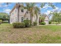 Two story home with lush green grass, mature trees, and a side entry garage at 239 Beacon Pointe Dr, Ocoee, FL 34761