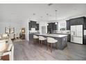 Modern kitchen featuring a large center island, stainless steel appliances, and sleek gray cabinetry at 12898 Harvest Rain Ave, Winter Garden, FL 34787