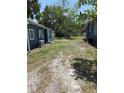 Spacious backyard area, great for outdoor activities, featuring a mix of grass and dirt between two properties at 2915 Winter Lake Rd, Lakeland, FL 33803