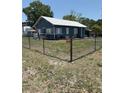 Inviting home featuring a metal roof and a chain-link fence enclosing the yard at 2915 Winter Lake Rd, Lakeland, FL 33803