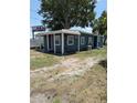 Cozy home with blue siding, visible air conditioning unit, and a mature tree in the yard at 2915 Winter Lake Rd, Lakeland, FL 33803