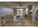 Bright and airy living room featuring hardwood floors, a comfy couch and neutral paint to create a relaxing atmosphere at 6300 Raleigh St # 102, Orlando, FL 32835
