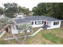 Aerial view of a single-story home with palm trees and a well-maintained lawn at 1816 W Lake Parker Dr, Lakeland, FL 33805