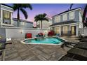 Private backyard pool and spa surrounded by pavers, lounge chairs, and mature landscaping at 7523 Excitement Dr, Kissimmee, FL 34747