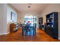 Bright dining room with hardwood floors, a large window, and a modern light fixture at 790 Country Charm Cir, Oviedo, FL 32765