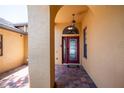 Covered front entryway showcasing a red door with decorative glass and brick paver flooring at 790 Country Charm Cir, Oviedo, FL 32765