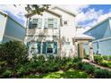 Charming two-story home with teal shutters and nicely landscaped yard at 1430 Reunion Blvd, Reunion, FL 34747