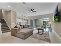 Spacious living room features tile floors, modern ceiling fan, and sliding glass doors to the pool area at 1430 Reunion Blvd, Reunion, FL 34747