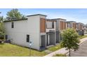 Side view of modern townhomes in a well-maintained community, offering a comfortable and stylish living experience at 3428 Tranquil Trail, Kissimmee, FL 34747