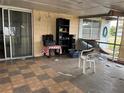Enclosed back patio features sliding glass doors, checkered floors, and outdoor storage at 801 Quintilian Ave, Orlando, FL 32809
