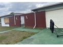 A closer side angle of a modest, single story home with brick and siding and garage at 801 Quintilian Ave, Orlando, FL 32809