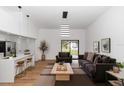 Bright living room featuring modern light fixture, vaulted ceilings, and stylish decor with sliding glass doors at 1161 Orangewood Ave, Deland, FL 32724