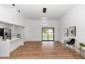 Bright living room featuring modern light fixture, vaulted ceilings, and stylish flooring with sliding glass doors at 1161 Orangewood Ave, Deland, FL 32724