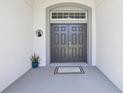 Welcoming double front door with a transom window, providing ample natural light and architectural interest at 229 St Thomas Dr, Mulberry, FL 33860