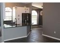 Modern kitchen features stainless steel appliances, elegant pendant lighting, and plenty of counter space at 938 Oxford Way, Lake Wales, FL 33853