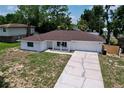Lovely single-story home featuring a brick exterior, attached garage and an extended driveway for ample parking at 212 Overlook Dr, Winter Haven, FL 33884