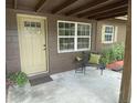 Inviting front porch with charming decor, seating area, and decorative door with a window at 2748 Cr 543, Sumterville, FL 33585