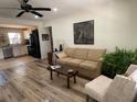 Open-concept living room with neutral colors, updated flooring, stylish furnishings and seamlessly connects to the kitchen at 2748 Cr 543, Sumterville, FL 33585