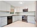 Modern kitchen with stainless steel appliances, light cabinetry, and sleek countertops at 1511 Avenue F Ne, Winter Haven, FL 33881