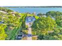 Gorgeous lakefront property featuring lush landscaping, a private driveway, and direct access to the serene lake at 390 Windermere Dr, Lakeland, FL 33809