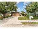 Inviting single-story home with a well-kept lawn, a two-car garage, and appealing curb appeal at 6898 Glenbrook Dr, Lakeland, FL 33811