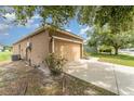 View of the side exterior highlighting the two-car garage and access to the driveway at 6898 Glenbrook Dr, Lakeland, FL 33811