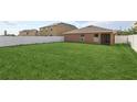 Spacious backyard featuring lush green grass and a white fence, great for outdoor activities at 109 James Cir, Lake Alfred, FL 33850