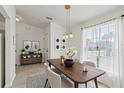 Cozy dining area featuring modern decor, a wooden table with seating for four, and bright natural light at 109 James Cir, Lake Alfred, FL 33850