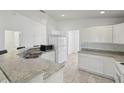 Bright kitchen features white cabinets, stainless steel sink, and modern appliances at 109 James Cir, Lake Alfred, FL 33850