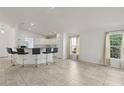 Open concept living space features tile floors, breakfast bar, and bright natural light at 109 James Cir, Lake Alfred, FL 33850