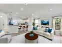 Bright living room with white walls, modern furniture, bar seating, and plenty of natural light at 109 James Cir, Lake Alfred, FL 33850