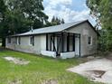 Dilapidated single story house showing siding damage, overgrown landscaping, and dated features at 408 S Orange Ave, Fort Meade, FL 33841